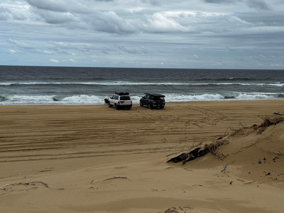 Beach background with 2 cars on the beach